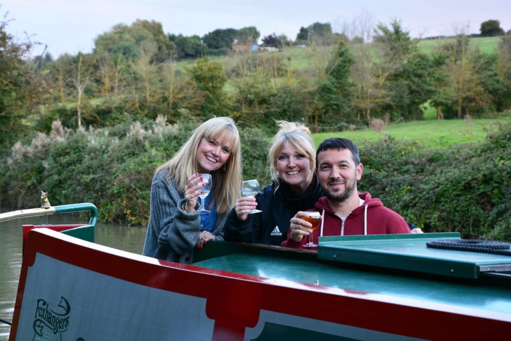 A group of freinds relaxing on their canal boat holiday