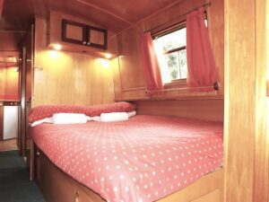 The double cabin on narrowboat Foxglove with a comfortable fixed double bed and plentiful storage.